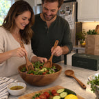 Tossing salad with acacia wood salad spoon and fork in a wooden bowl